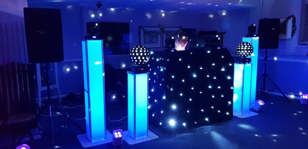 Mr Beats DJ setup with illuminated lighting columns and disco lights at an event